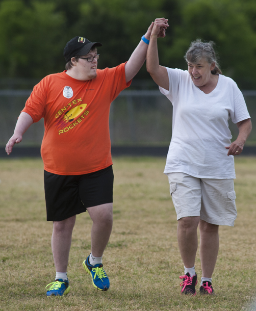 An athlete gets a high-five from his biggest supporter, his mom.