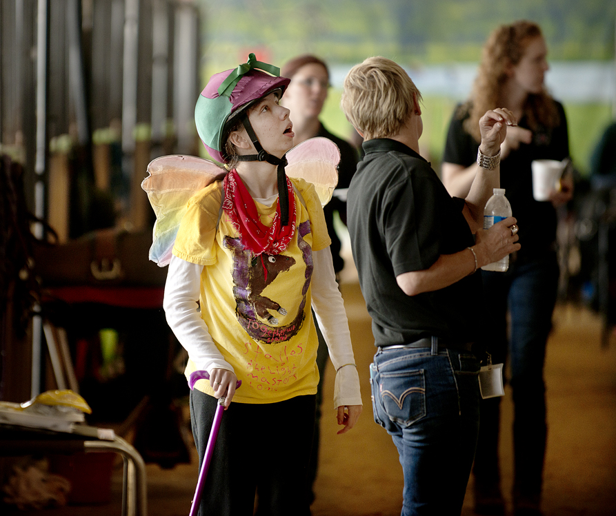 Athlete Elle Adams, who "always wears her wings," says her mom, learns that she has won a medal.